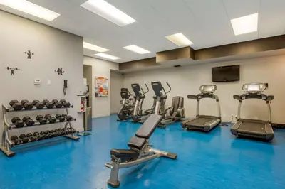 a gym with several treadmills and machines at Best Western Plus Village Park Inn in Calgary