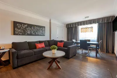 a living room with a couch and a table at Best Western Plus Village Park Inn in Calgary