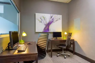 an office with a desk with a computer and a monitor at Best Western Plus Village Park Inn in Calgary