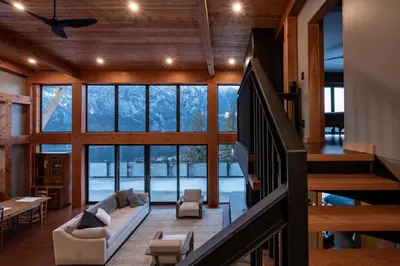 a living room with a couch and a staircase at Luxe Modern Timberframe - Iconic Panorama Views with AC in Nelson