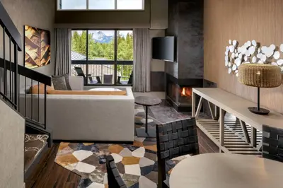 a living room with a couch and a fireplace at Kananaskis Mountain Lodge, Autograph Collection in Kananaskis Village