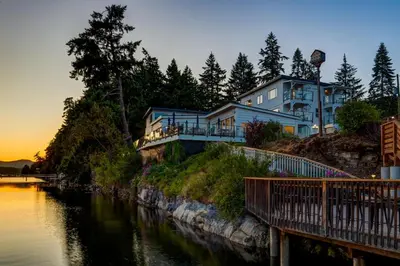 a house sitting on top of a hill next to a river at Manana Resort and Marina in Ladysmith