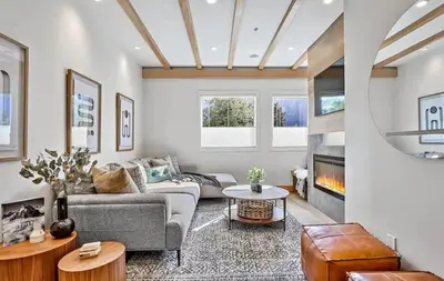 a living room with a couch and a fireplace at Ravens Crest Lodge - Stunning Views Perfectly Located on Main Street in Canmore