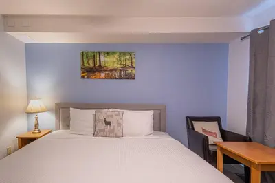 a bedroom with a bed and a table and a desk at Hotel Room in Windtower Lodge-121 in Canmore