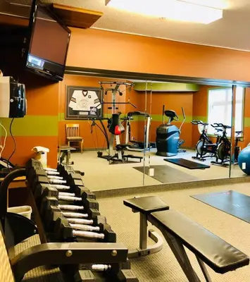 a gym with bikes and exercise equipment in a room at Hotel Room in Windtower Lodge-121 in Canmore