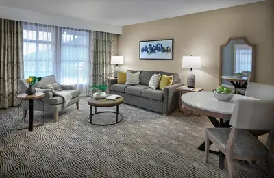 a living room with a couch and a table at Sun Peaks Grand Hotel & Conference Centre in Sun Peaks