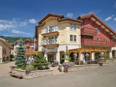 a large building with a lot of plants in front of it at Sun Peaks Grand Hotel & Conference Centre in Sun Peaks