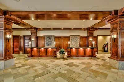 a lobby with wood paneling and a lobby with a plant at Sun Peaks Grand Hotel & Conference Centre in Sun Peaks