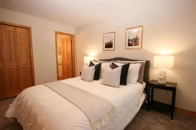 a bedroom with a large white bed with pillows at 2BR in Crystal Forest, Ski In, Ski Out, Fireplace, Private Hot Tub, Steps to the Village in Sun Peaks