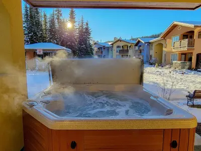 a jacuzzi tub with snow in a yard at 2BR in Crystal Forest, Ski In, Ski Out, Fireplace, Private Hot Tub, Steps to the Village in Sun Peaks