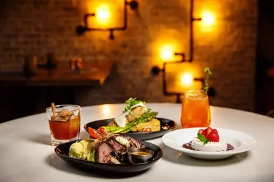 a table with two plates of food and a drink at Delta Hotels by Marriott Edmonton Centre Suites in Edmonton