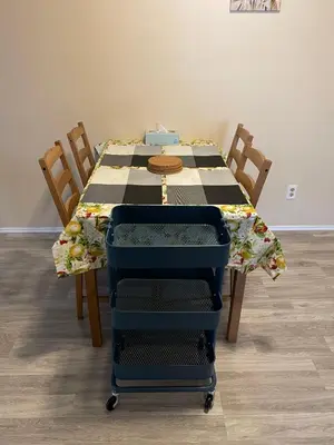 a table with a chair and a table with a table cloth at MT Pleasant NW 2 bedrooms 500 in Calgary