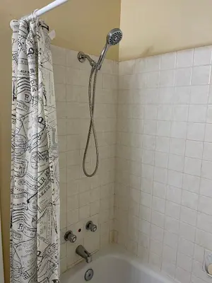 a bathroom with a shower and a bath tub at MT Pleasant NW 2 bedrooms 500 in Calgary
