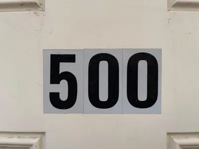 a number sign on the side of a building at MT Pleasant NW 2 bedrooms 500 in Calgary