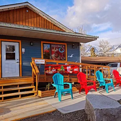a group of chairs sitting outside of a house at Cozy Corner Motel & Restaurant in Haines Junction