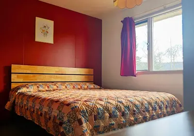 a bedroom with a bed and a window at Cozy Corner Motel & Restaurant in Haines Junction