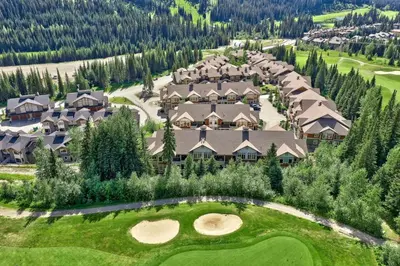 an aerial view of a resort with a golf course at Settlers Crossing #29 By Bear Country in Sun Peaks