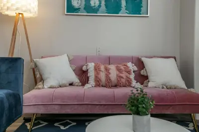 a purple couch with pillows on it in a living room at Mediterranean Retreat - King Bed - Fireplace - Garage in Edmonton