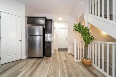 a kitchen with a stainless steel refrigerator and a plant at Mediterranean Retreat - King Bed - Fireplace - Garage in Edmonton