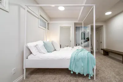 a white bed in a room with a mirror at Mediterranean Retreat - King Bed - Fireplace - Garage in Edmonton