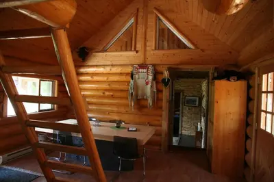 a room with a desk in a wooden cabin at LDR Lodge - Last Dollar Ranch in Smithers