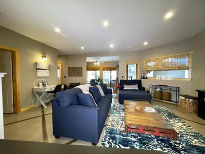 a living room with a blue couch and a table at Blanchard Mountain BnB in Canmore