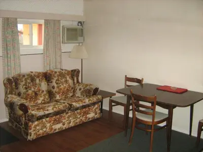 a living room with a couch and a table at Airport Inn in Quesnel