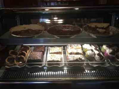 an oven filled with different types of cakes and pastries at Old Towne Inne Chuckwagon Bar & Grill in Boston Bar