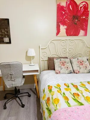 a bedroom with a bed and a desk with a chair at Banff mountain House&30 second Bus station Close C-Train& Free Parking in Calgary