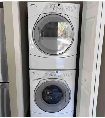 two washing machines stacked on top of each other at Banff mountain House&30 second Bus station Close C-Train& Free Parking in Calgary