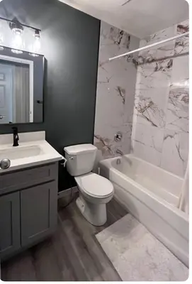 a bathroom with a toilet and a tub and a sink at Banff mountain House&30 second Bus station Close C-Train& Free Parking in Calgary