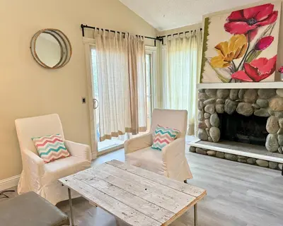 a living room with a table and chairs and a fireplace at Banff mountain House&30 second Bus station Close C-Train& Free Parking in Calgary
