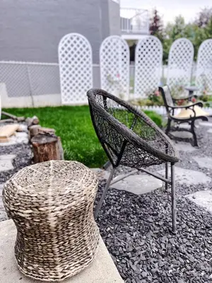 a wicker chair and a basket on a patio at Banff Garden Suite&2mins Bus station Close LRT& Free Parking in Calgary