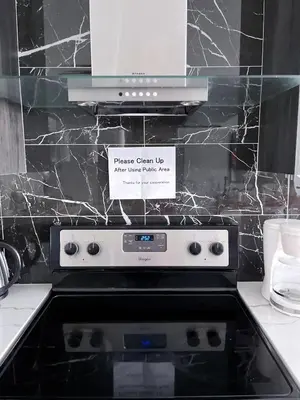 a kitchen with a stove with a sign on it at Banff Garden Suite&2mins Bus station Close LRT& Free Parking in Calgary