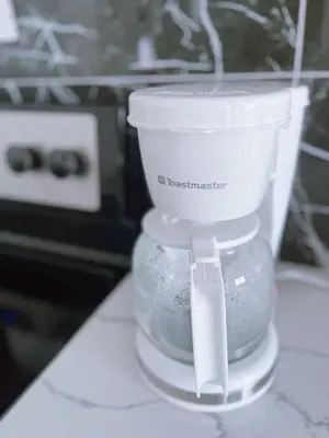a white food processor sitting on top of a counter at Banff Garden Suite&2mins Bus station Close LRT& Free Parking in Calgary