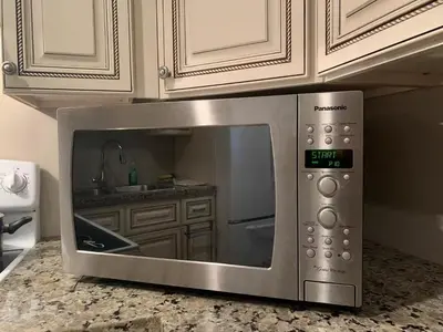 a microwave oven sitting on top of a kitchen counter at Mae Sweet Home in Surrey