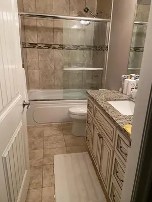 a bathroom with a tub and a toilet and a sink at Mae Sweet Home in Surrey