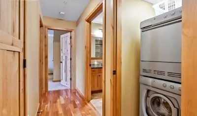 a laundry room with a washer and dryer at Luxurious Rundle Cliffs Lodge in Spring Creek in Canmore