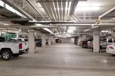 a large parking garage with cars parked in it at Luxurious Rundle Cliffs Lodge in Spring Creek in Canmore