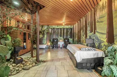 a bedroom with a bed in a room with plants at Carbon Valley Ranch in Grainger