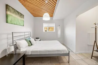 a white bedroom with a bed and a table at Carbon Valley Ranch in Grainger