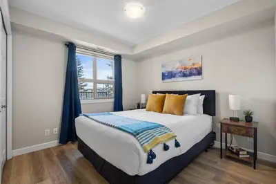 a bedroom with a large bed and a window at The Altitude Landing, Pool, Hot Tub, Pets in Invermere