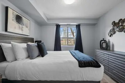 a bedroom with a large bed and a window at The Altitude Landing, Pool, Hot Tub, Pets in Invermere