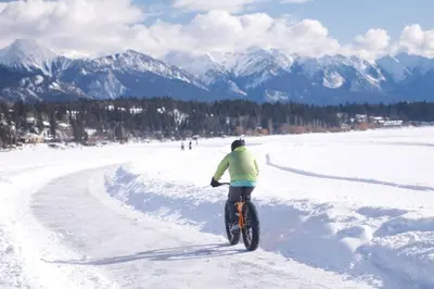 a person riding a bike in the snow at The Altitude Landing, Pool, Hot Tub, Pets in Invermere