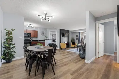 a dining room and living room with a table and chairs at The Altitude Landing, Pool, Hot Tub, Pets in Invermere
