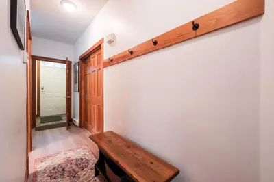 a hallway with a wooden shelf on the wall at Granite Court by Outpost Whistler in Whistler