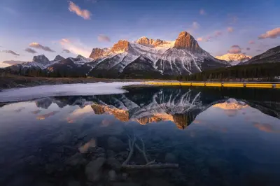 a reflection of a mountain in a lake at Romantic Studio with Kitchen & AC & BBQ & a Huge Balcony 164 in Canmore