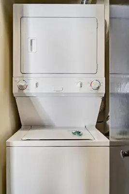a white refrigerator freezer with twoartmentsyss at Nature's Nook by Instant Suites Pool & HotTub in Canmore