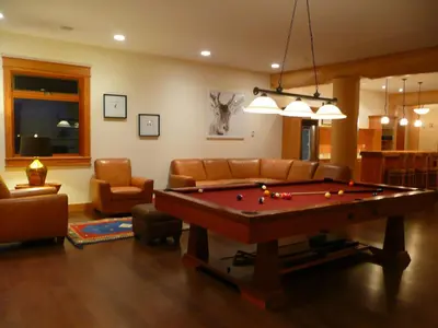 a living room with a pool table in it at Jollymore Ranch in Smithers