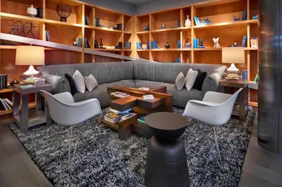 a living room with a couch and a table and chairs at Renaissance Edmonton Airport Hotel in Nisku